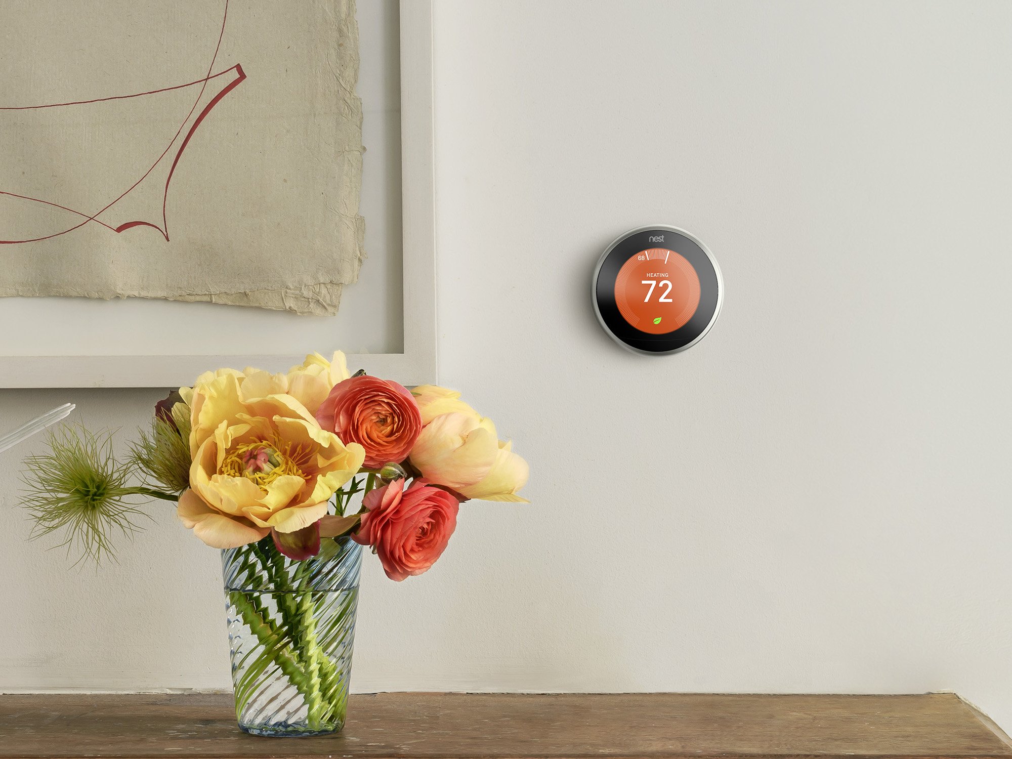 Lifestyle photo of a Nest Learning Thermostat on the wall of a home