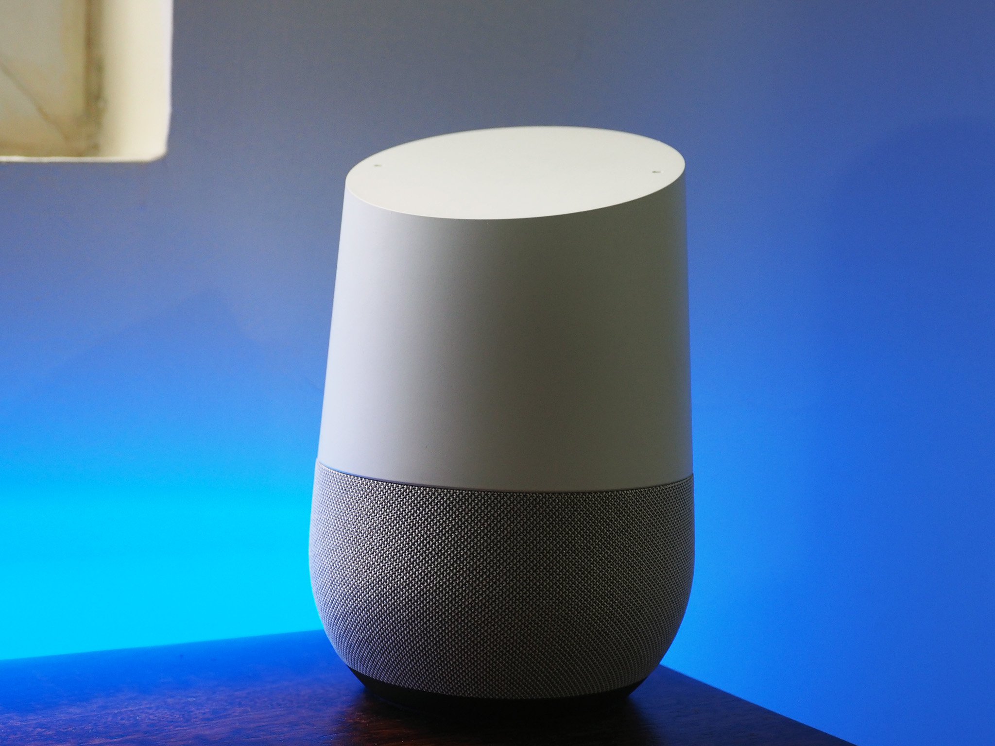 Google Home with blue lighting behind it