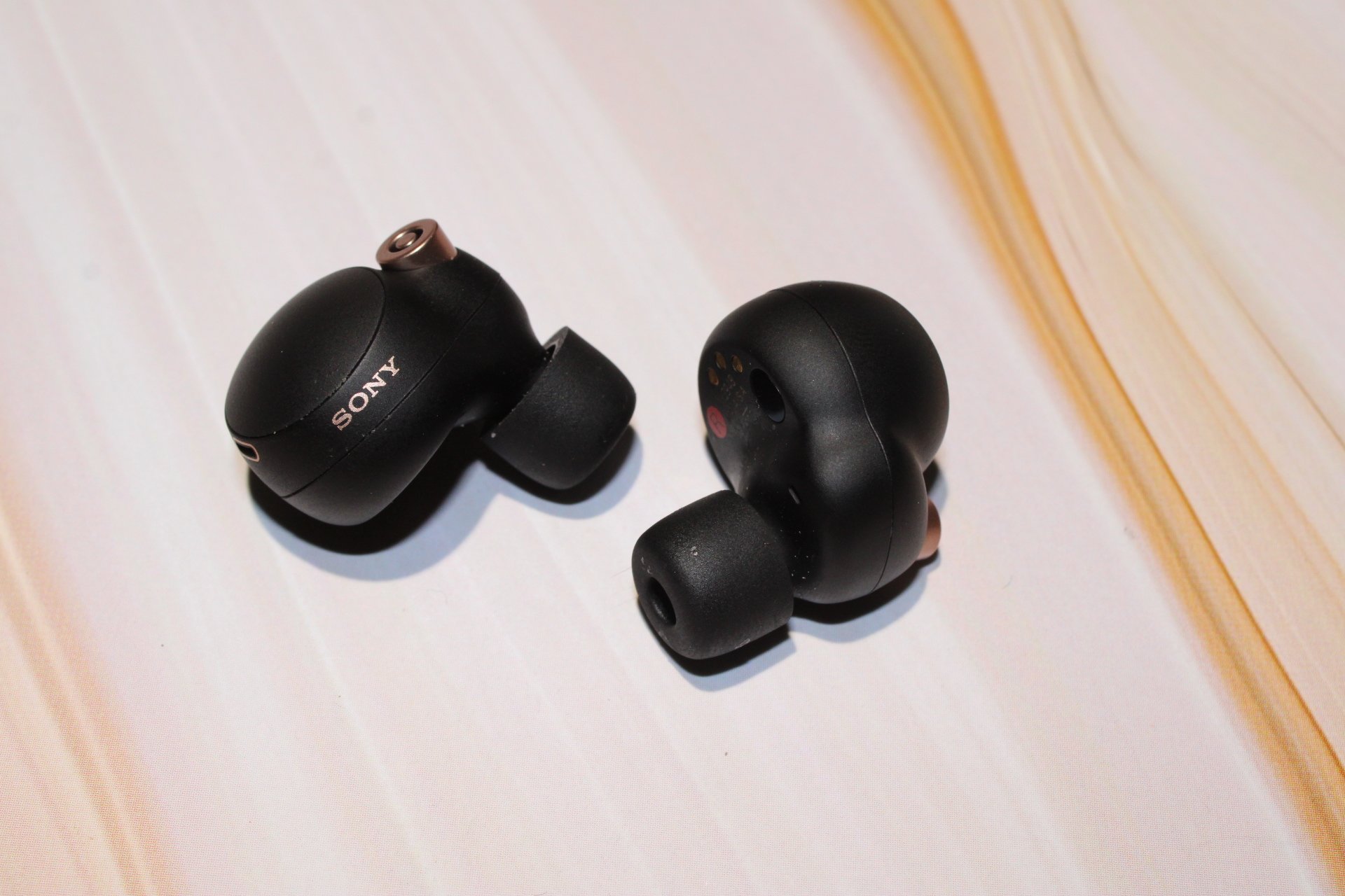 Sony Wf1000xm4 earbuds lying on table