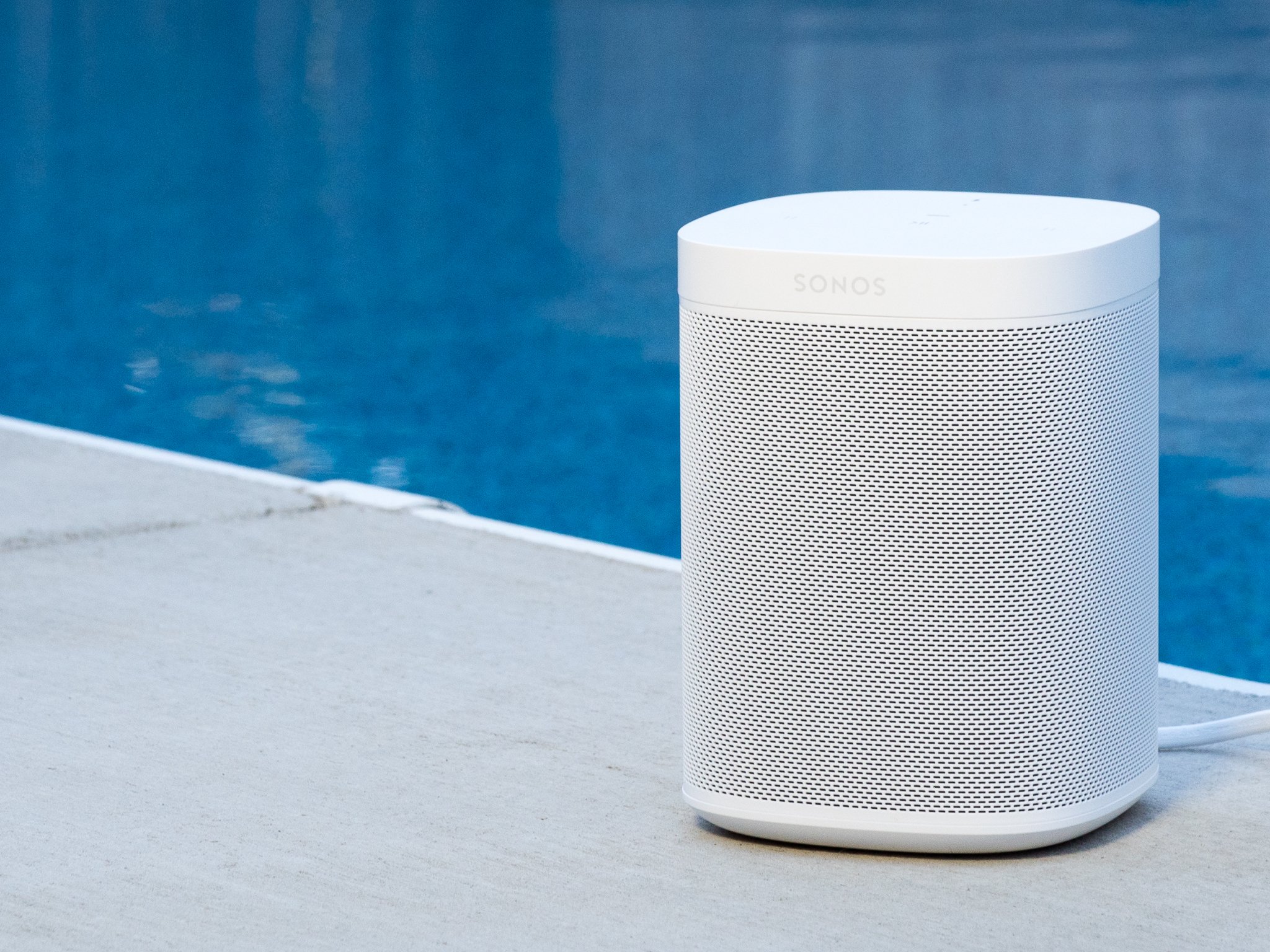 Sonos One in white next to a pool