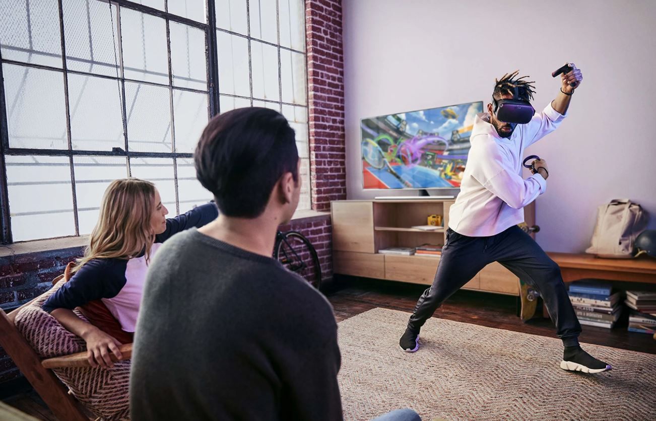 Marketing photo of a person standing while using Oculus Quest and Touch controllers
